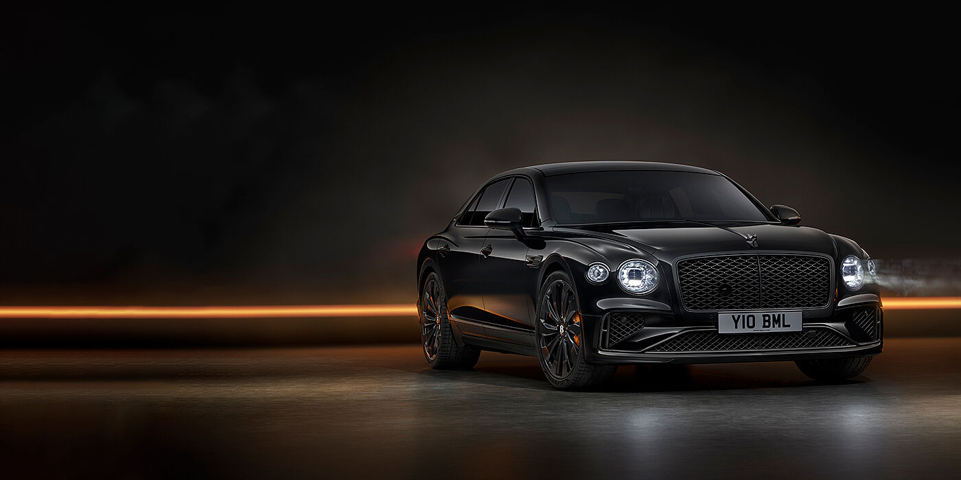 Bentley Douglas Bentley Flying Spur Black Edition sedan in Black Crystal paint against a dark grey and copper coloured background