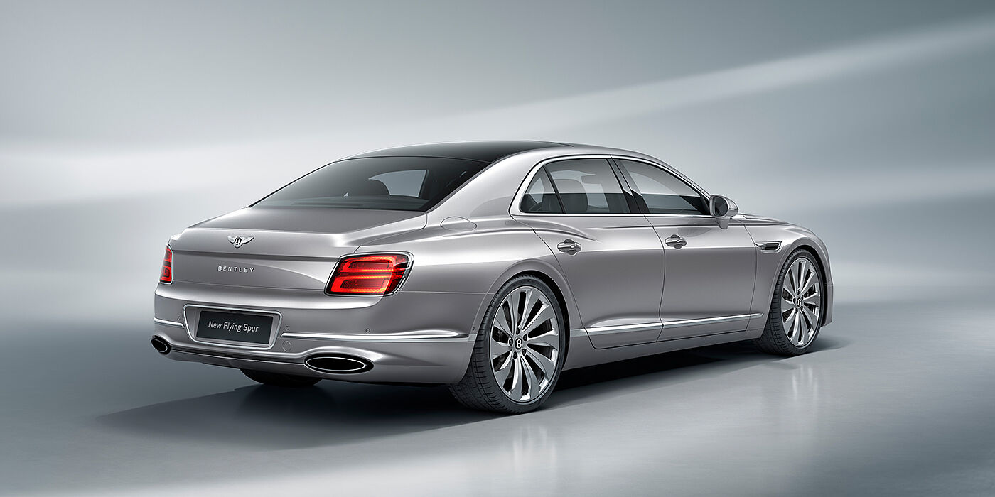 Bentley Douglas New Bentley Flying Spur sedan rear view in Silverlake paint with ten spoke wheels and chrome matrix grille