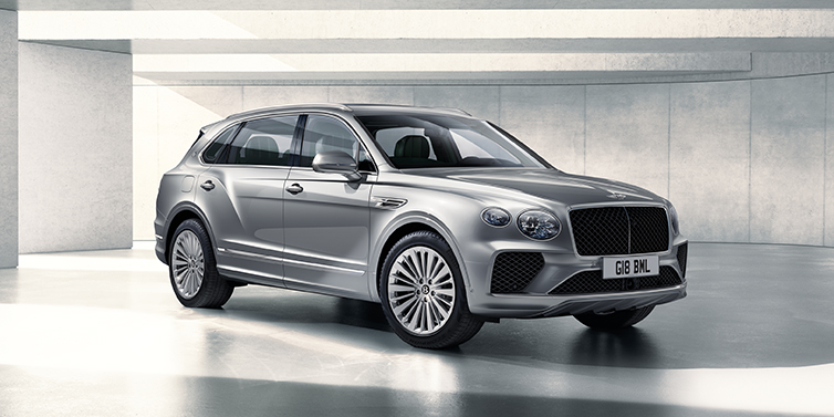 Bentley Douglas Bentley Bentayga Extended Wheelbase SUV front three quarter in Moonbeam paint with a grey background